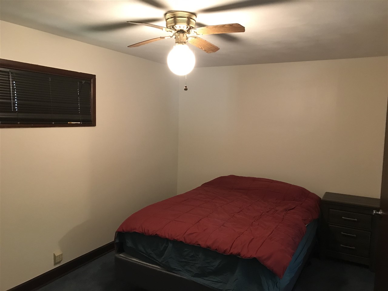 7632 North River Road Byron, IL 61010 - Photo 10 of 15 a bedroom with a bed and a chandelier