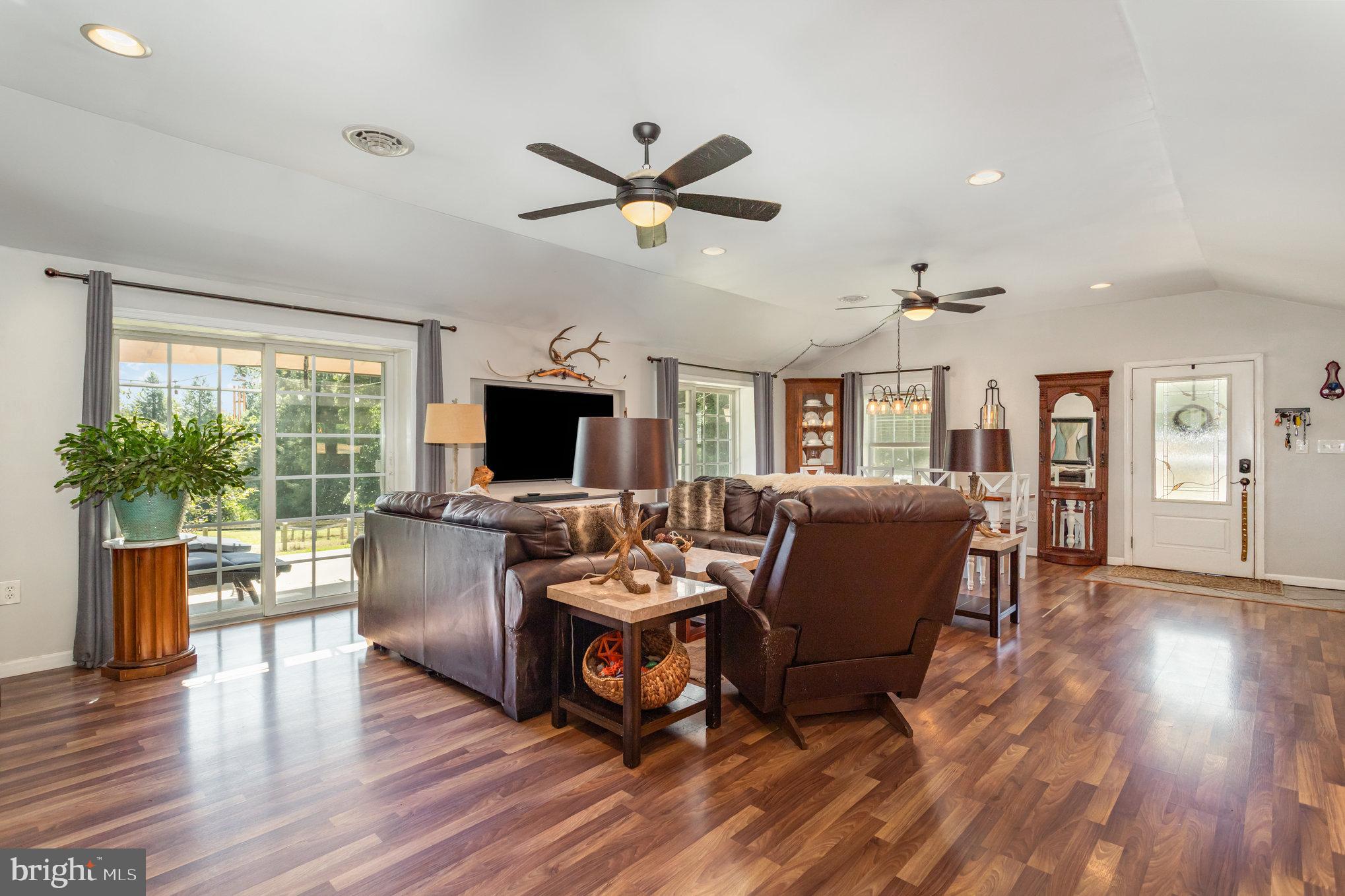 136 Greenwich Road Delta, PA 17314 - Photo 11 of 56 a living room with furniture a flat screen tv and a large window