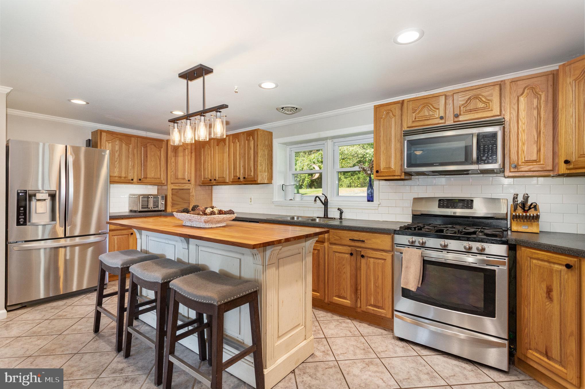 136 Greenwich Road Delta, PA 17314 - Photo 13 of 56 a kitchen with stainless steel appliances granite countertop a stove a sink dishwasher a refrigerator and a microwave