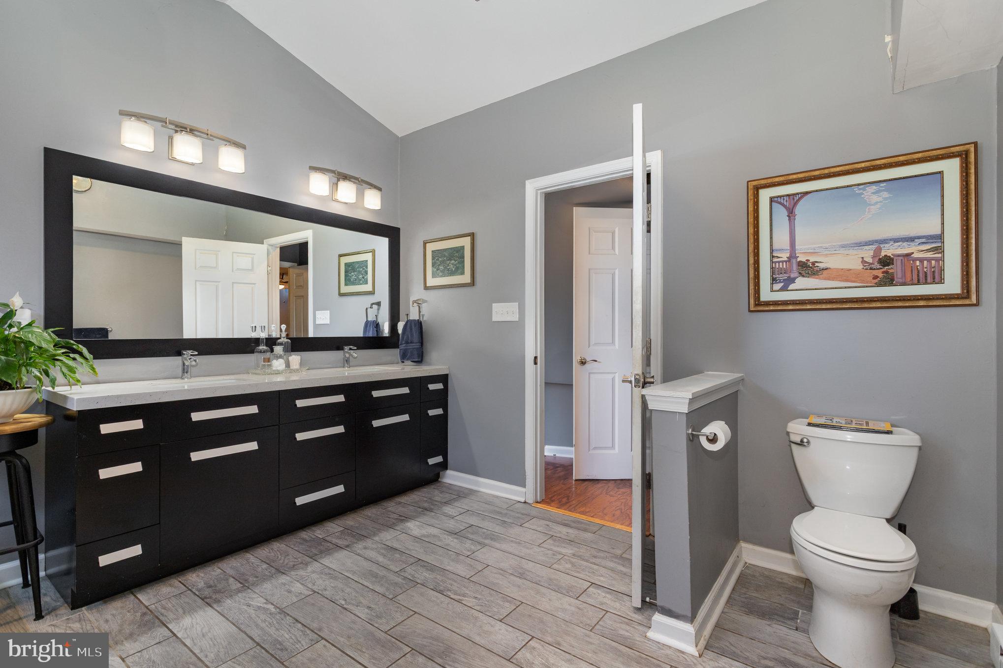136 Greenwich Road Delta, PA 17314 - Photo 20 of 56 a spacious bathroom with a granite countertop toilet sink and mirror