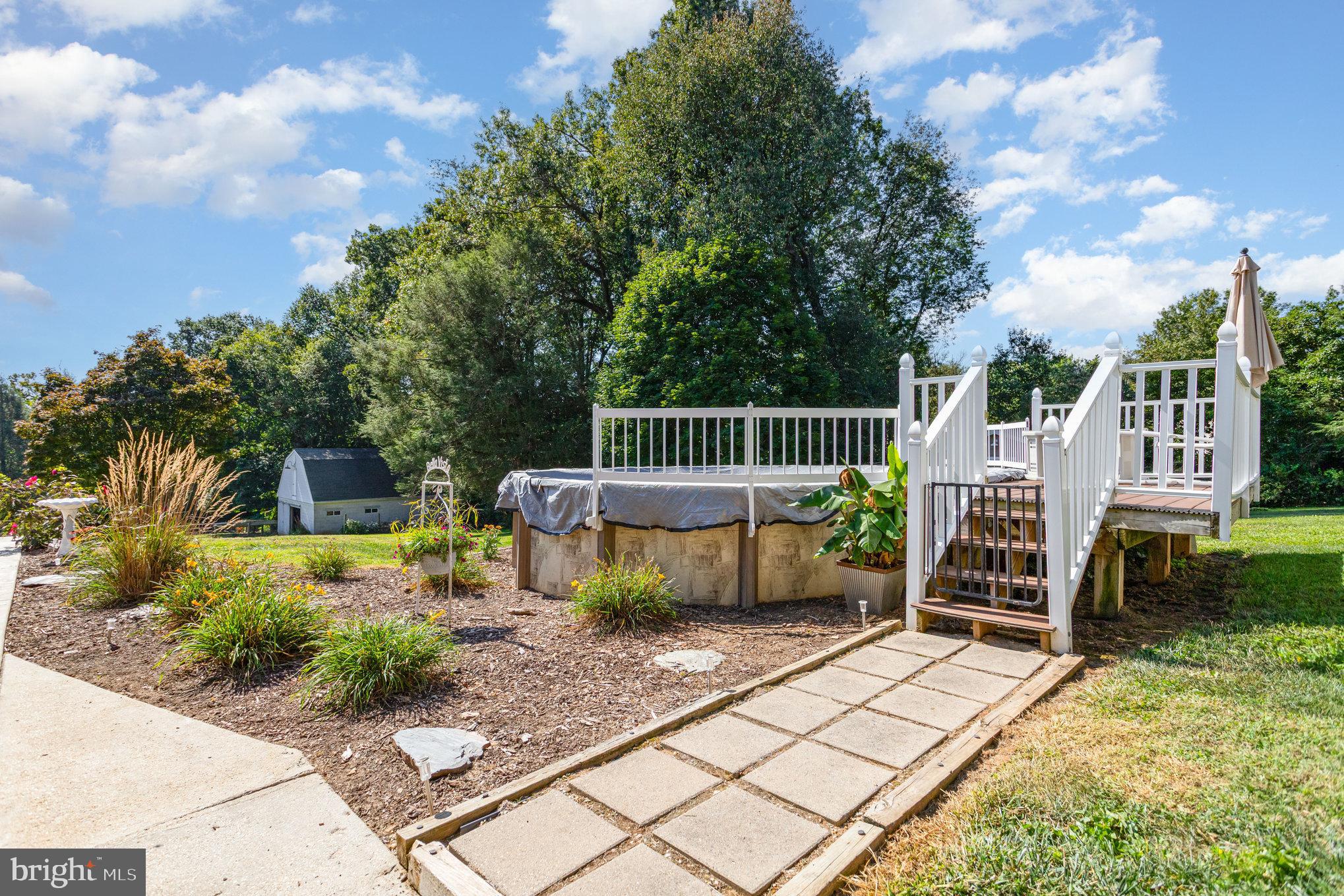 136 Greenwich Road Delta, PA 17314 - Photo 38 of 56 a view of a deck with a table and chairs next to a yard