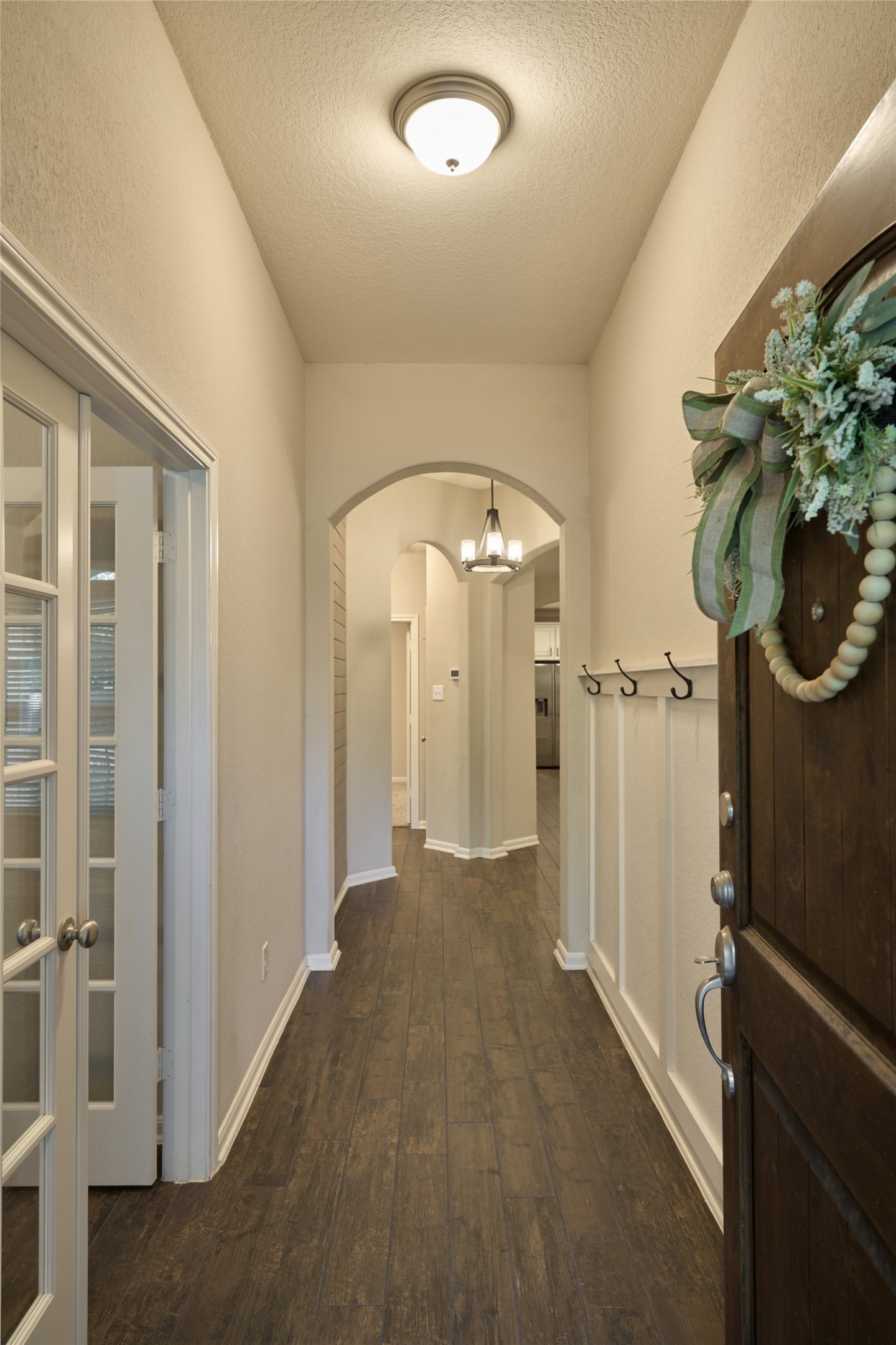 116 Fox Trail Road Montgomery, TX 77316 - Photo 4 of 50 The welcoming entryway features a wooden door. The French doors lead to the office, and beyond that leads to the main living area.