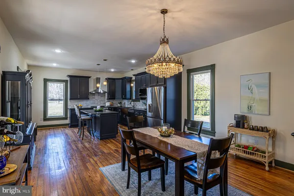 a view of a dining room and livingroom with furniture window and wooden floor