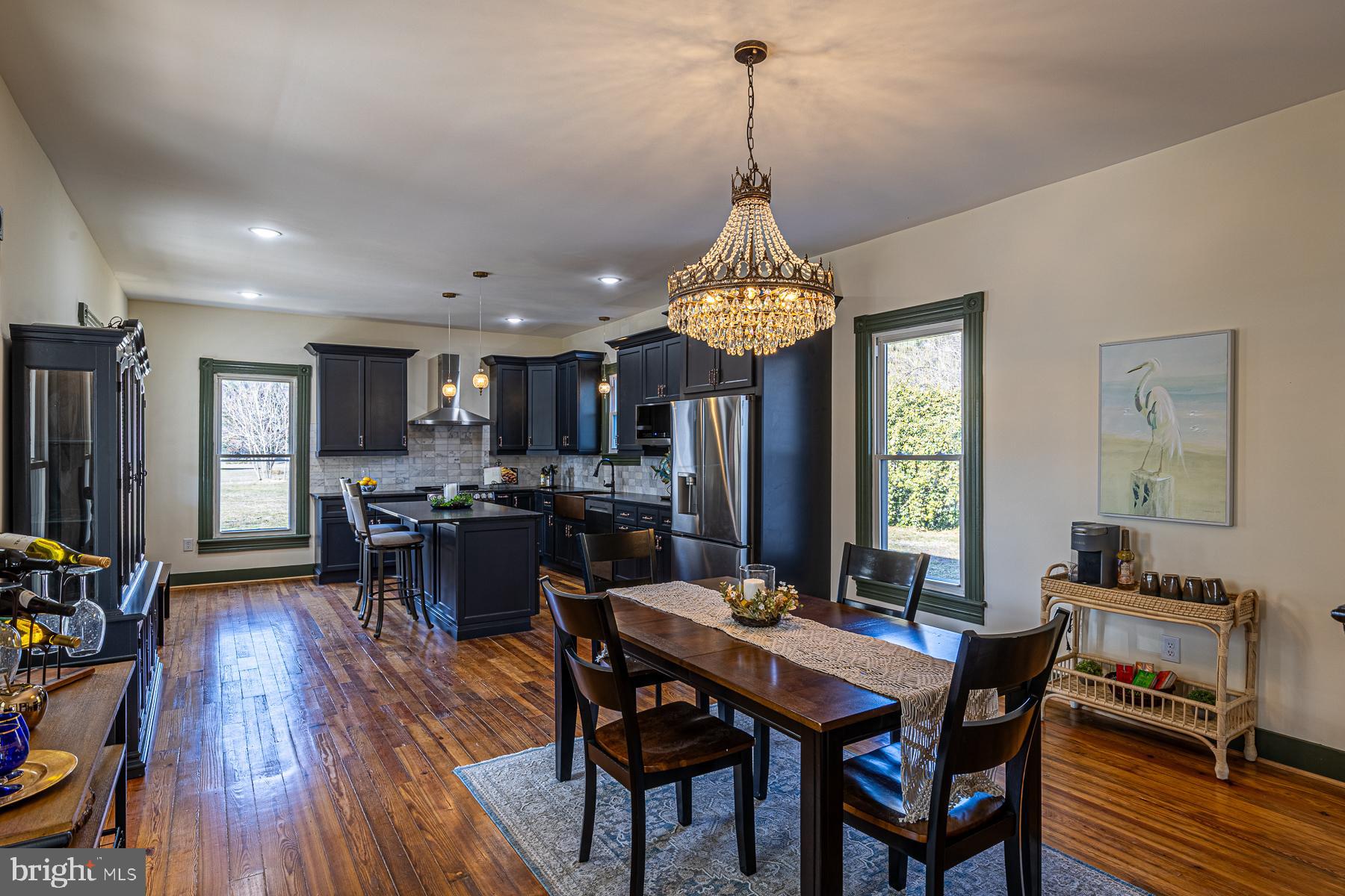 296 Beach Road White Stone, VA 22578 - Photo 13 of 51 a view of a dining room and livingroom with furniture window and wooden floor