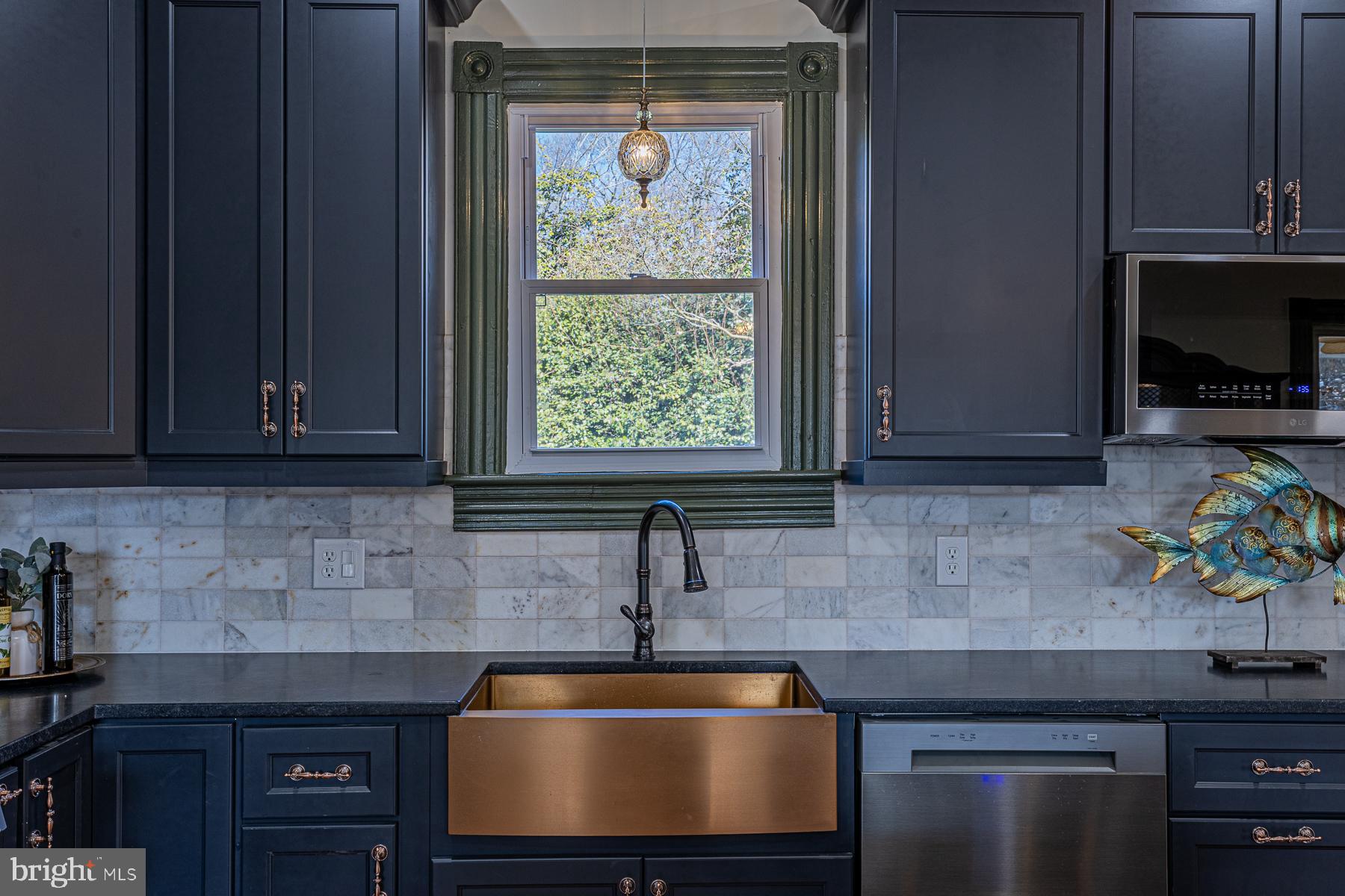 296 Beach Road White Stone, VA 22578 - Photo 18 of 51 a kitchen with stainless steel appliances granite countertop a sink and a microwave