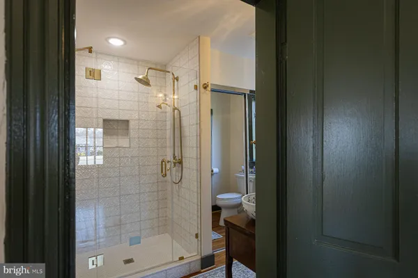 a view of a hallway with windows and stairs
