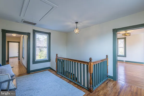a view of staircase with wooden floor and a window