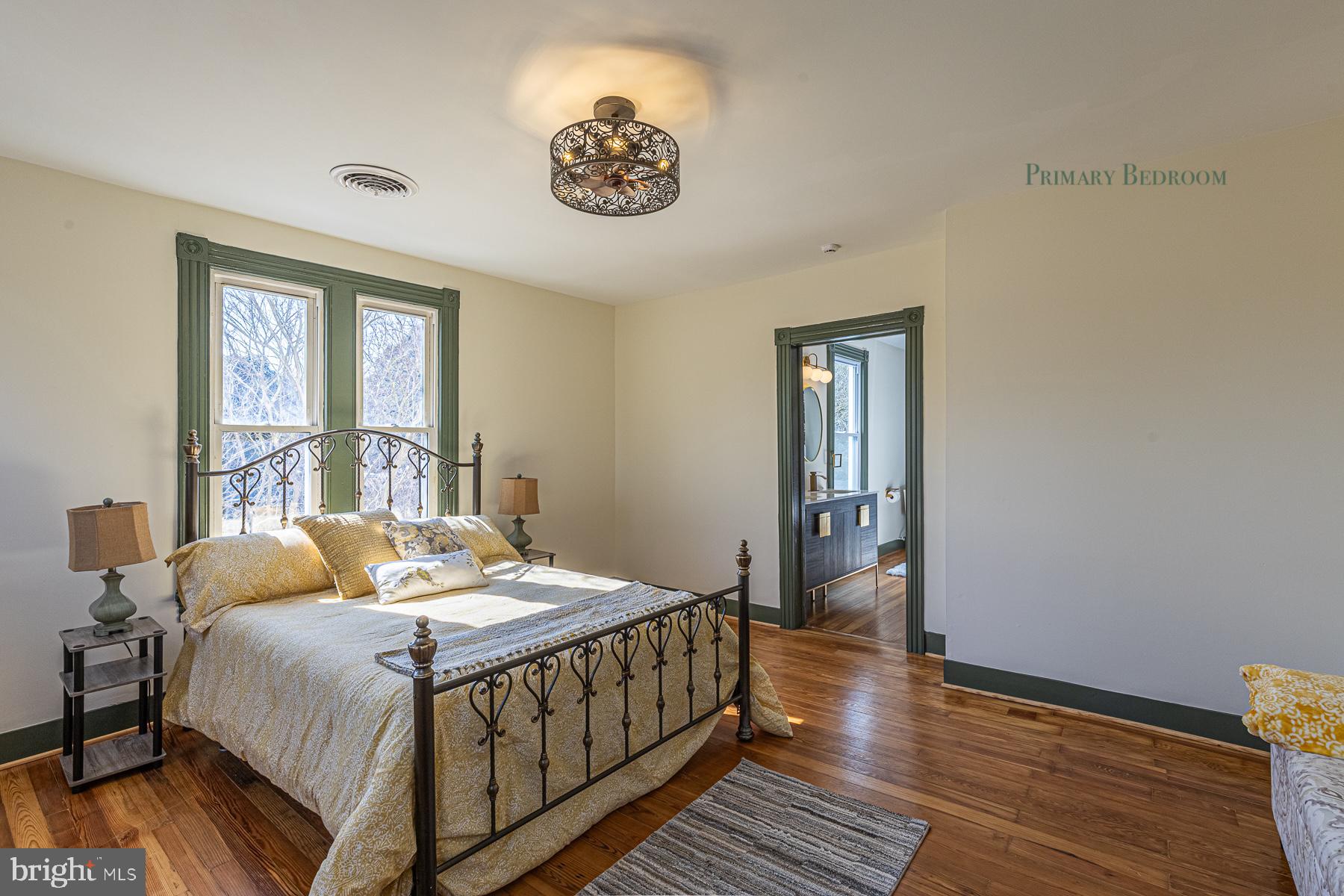 296 Beach Road White Stone, VA 22578 - Photo 28 of 51 a bedroom with a bed and wooden floor