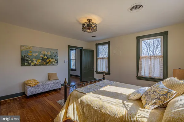 a living room with large mirror and a table
