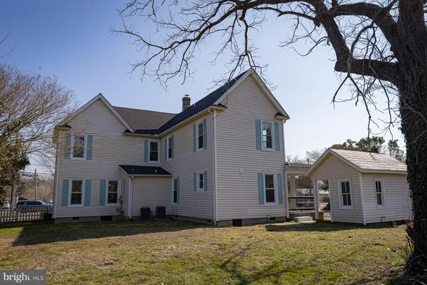 a view of a house with a yard covered in snow