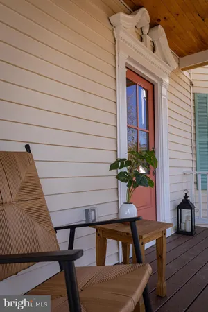 a balcony with table and chairs