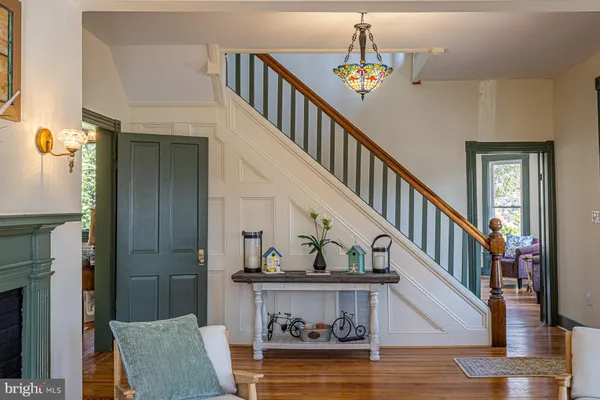 a view of entryway and hall with wooden floor