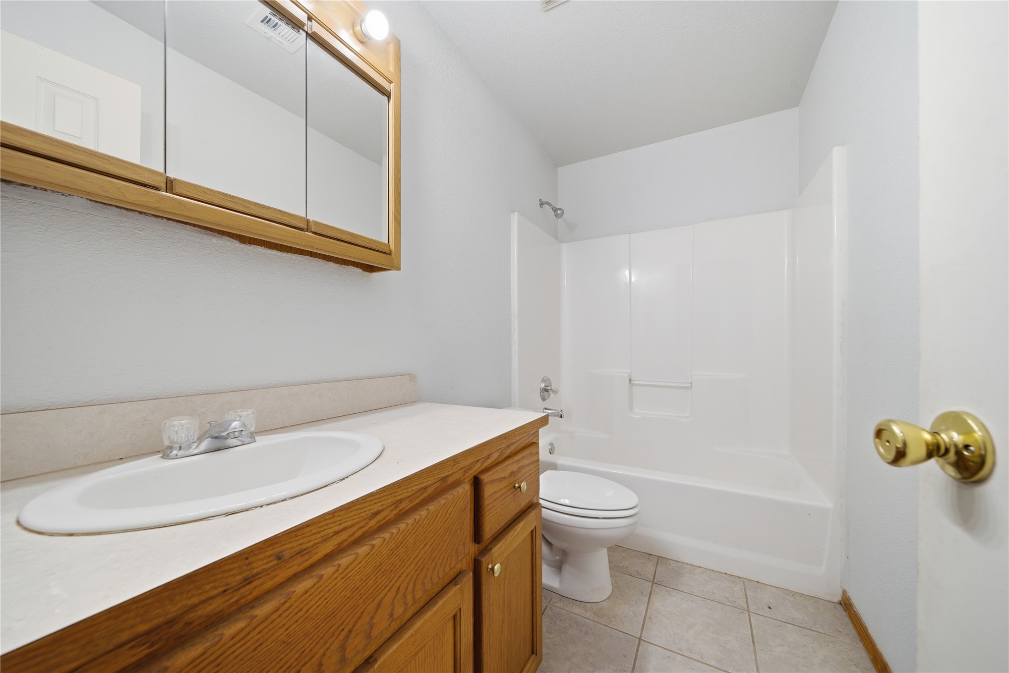 511 Cemetery Road Oktaha, OK 74450 - Photo 21 of 28 Wood-finish vanity with a drop-in sink, integrated countertop, and brass-finish hardware