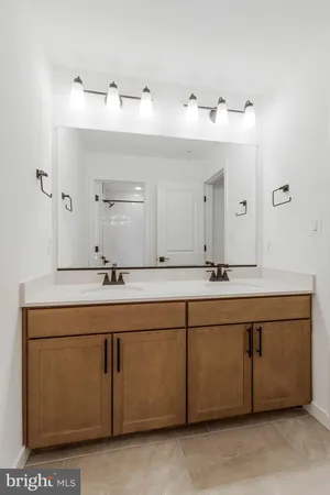 a bathroom with a double vanity sink and mirror