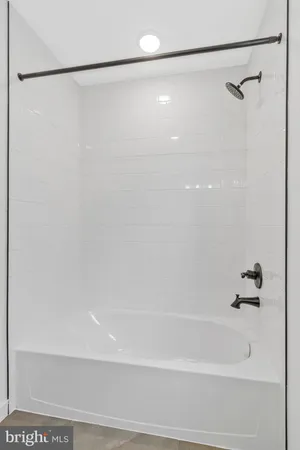a bathroom with a shower and a bath tub