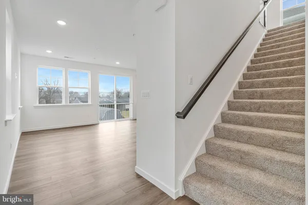 a view of an entryway with wooden floor and door