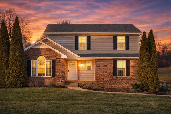 a front view of a house with a garden