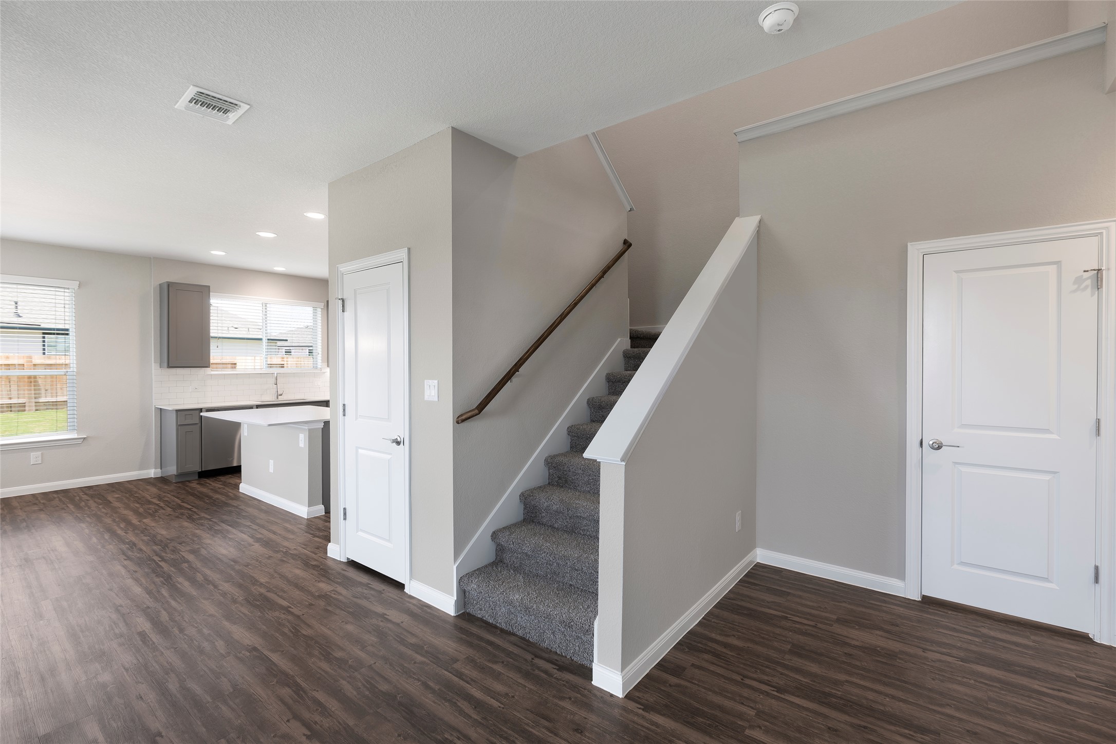 424 San Gabriel River Road Georgetown, TX 78626 - Photo 7 of 8 An open concept living area transitions seamlessly to the kitchen, featuring sleek cabinetry and a center island.