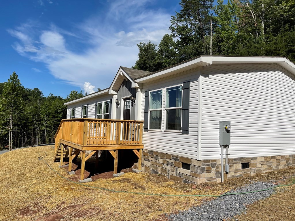 1348 Bluets Road Newport, TN 37821 - Photo 32 of 47 a view of a white house with a yard and wooden fence