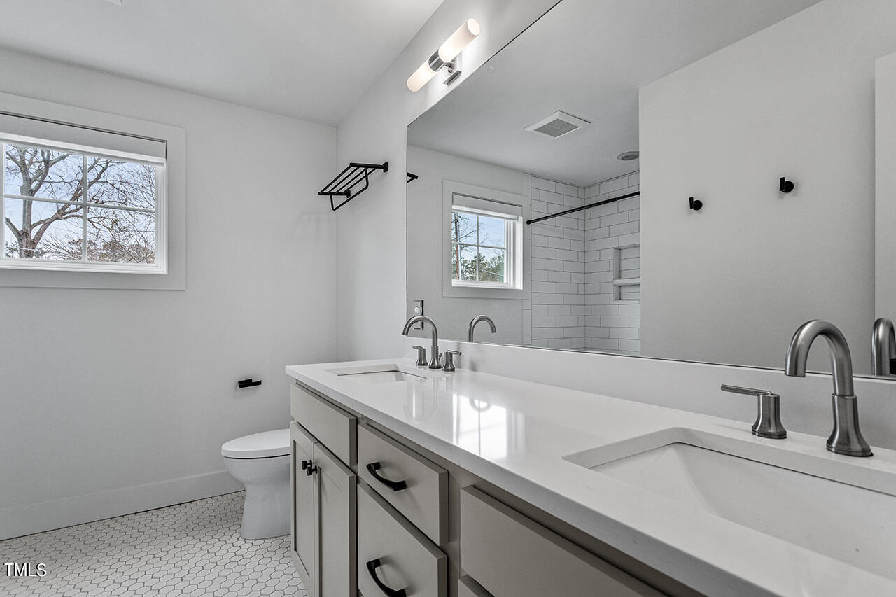 609 Frank Street Raleigh, NC 27604 - Photo 16 of 24 Upstairs bath with double vanity, tile tub/ shower