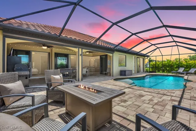 a view of a patio with a table and chairs and potted plants