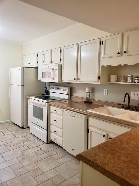 6500 Gaines Ferry Road, Unit I4 Flowery Branch, GA 30542 - Photo 14 of 30 a kitchen with white cabinets stainless steel appliances and sink