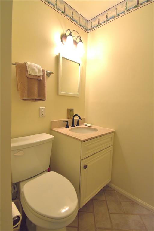 6500 Gaines Ferry Road, Unit I4 Flowery Branch, GA 30542 - Photo 18 of 30 a bathroom with a sink mirror vanity and toilet