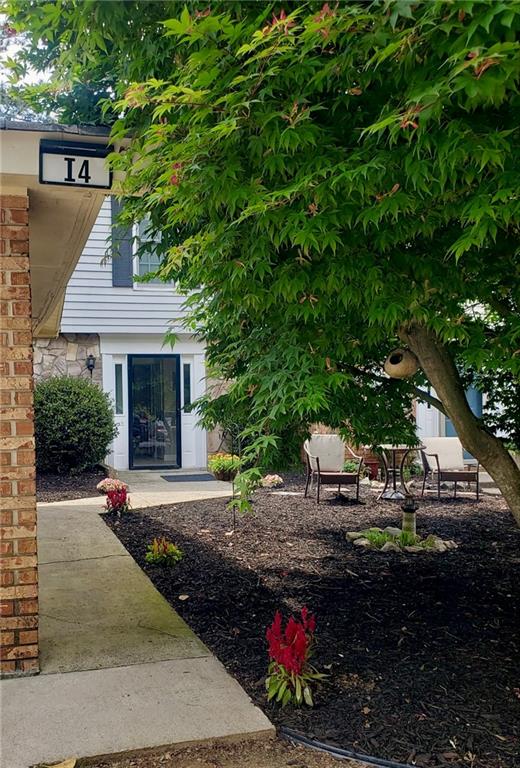 6500 Gaines Ferry Road, Unit I4 Flowery Branch, GA 30542 - Photo 2 of 30 a front view of a house with a yard