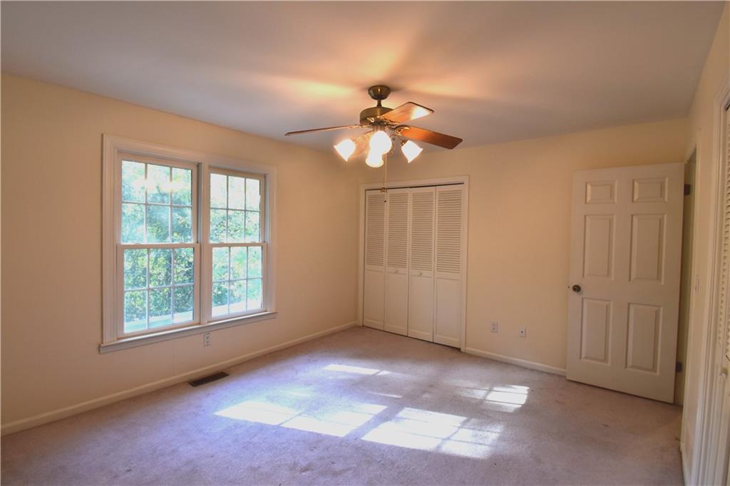 6500 Gaines Ferry Road, Unit I4 Flowery Branch, GA 30542 - Photo 22 of 30 an empty room with windows and fan