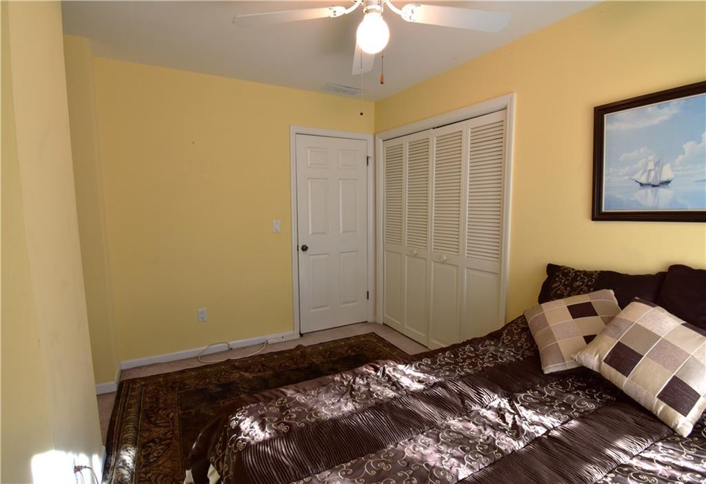 6500 Gaines Ferry Road, Unit I4 Flowery Branch, GA 30542 - Photo 24 of 30 a bedroom with a bed and the view of bathroom