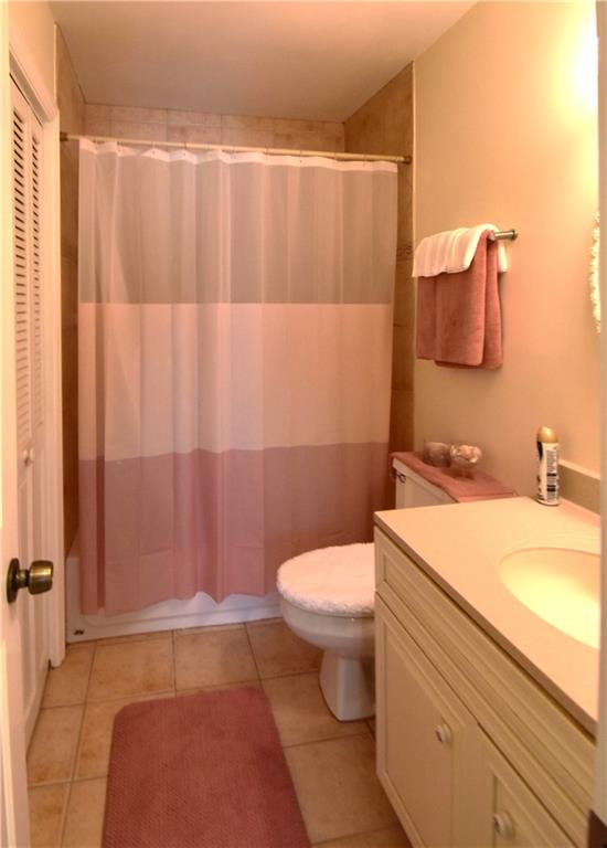 6500 Gaines Ferry Road, Unit I4 Flowery Branch, GA 30542 - Photo 25 of 30 a bathroom with a granite countertop toilet and a sink