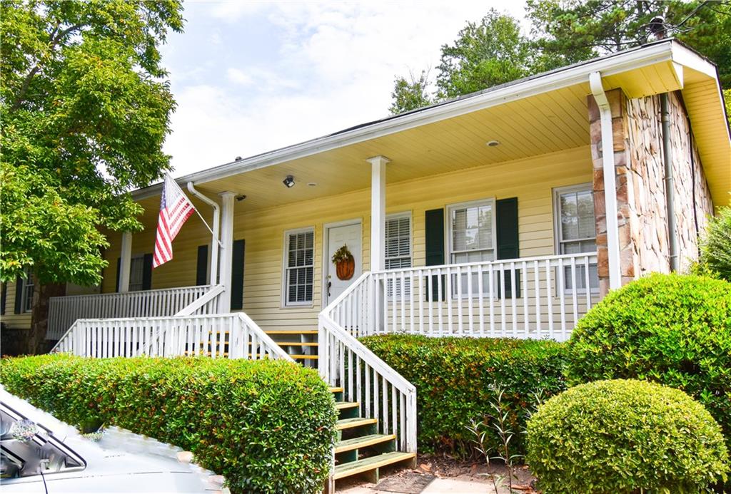 6500 Gaines Ferry Road, Unit I4 Flowery Branch, GA 30542 - Photo 27 of 30 a view of a house with a small yard and wooden fence