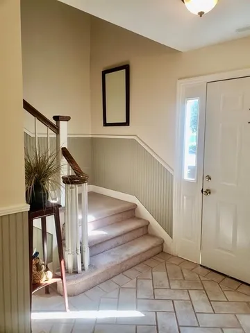 a view of entryway and hall with a front door