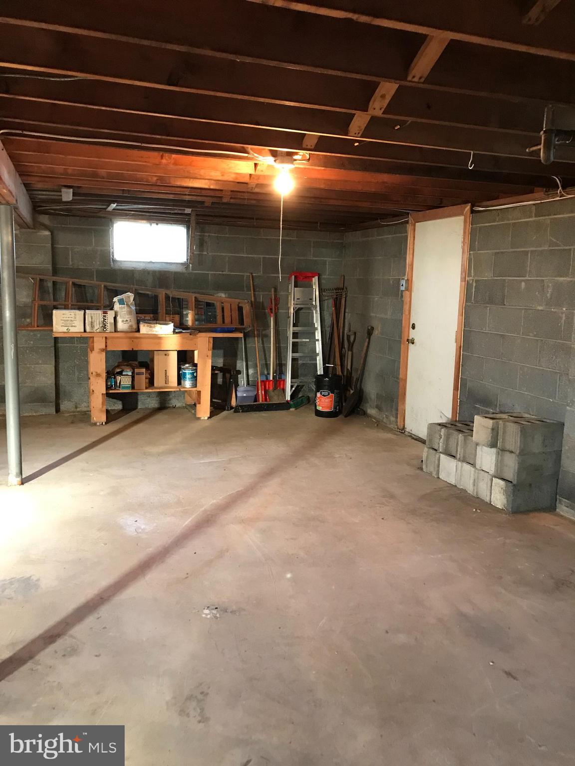 39 Elmont Road Trenton, NJ 08610 - Photo 14 of 18 Workbench in Basement with access to Backyard