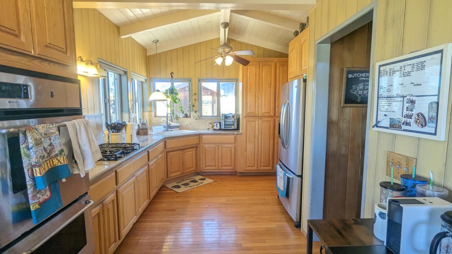 20473 Panoche Road Paicines, CA 95043 - Photo 11 of 19 a kitchen with stainless steel appliances a refrigerator and a stove