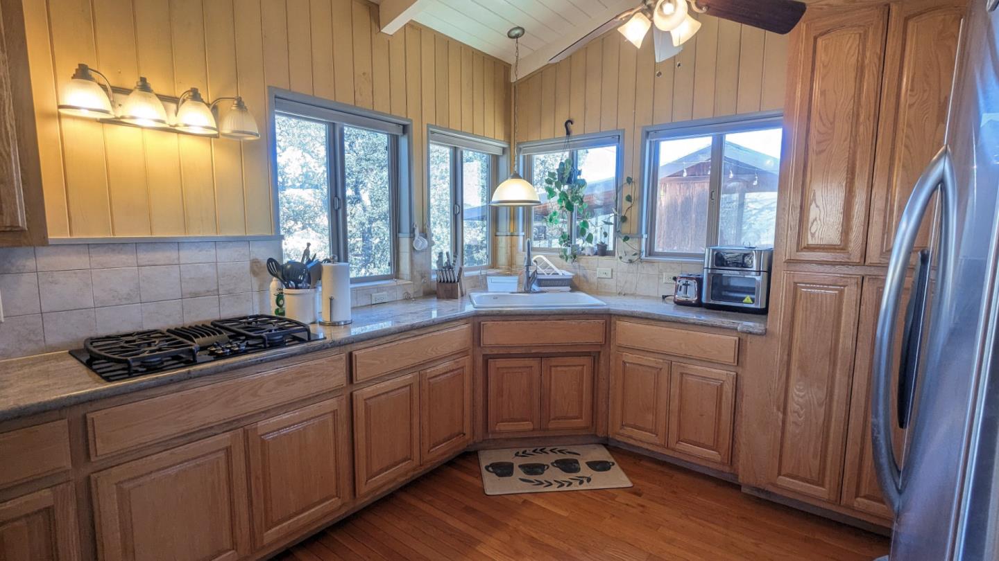 20473 Panoche Road Paicines, CA 95043 - Photo 12 of 19 a kitchen with stainless steel appliances a sink stove and cabinets