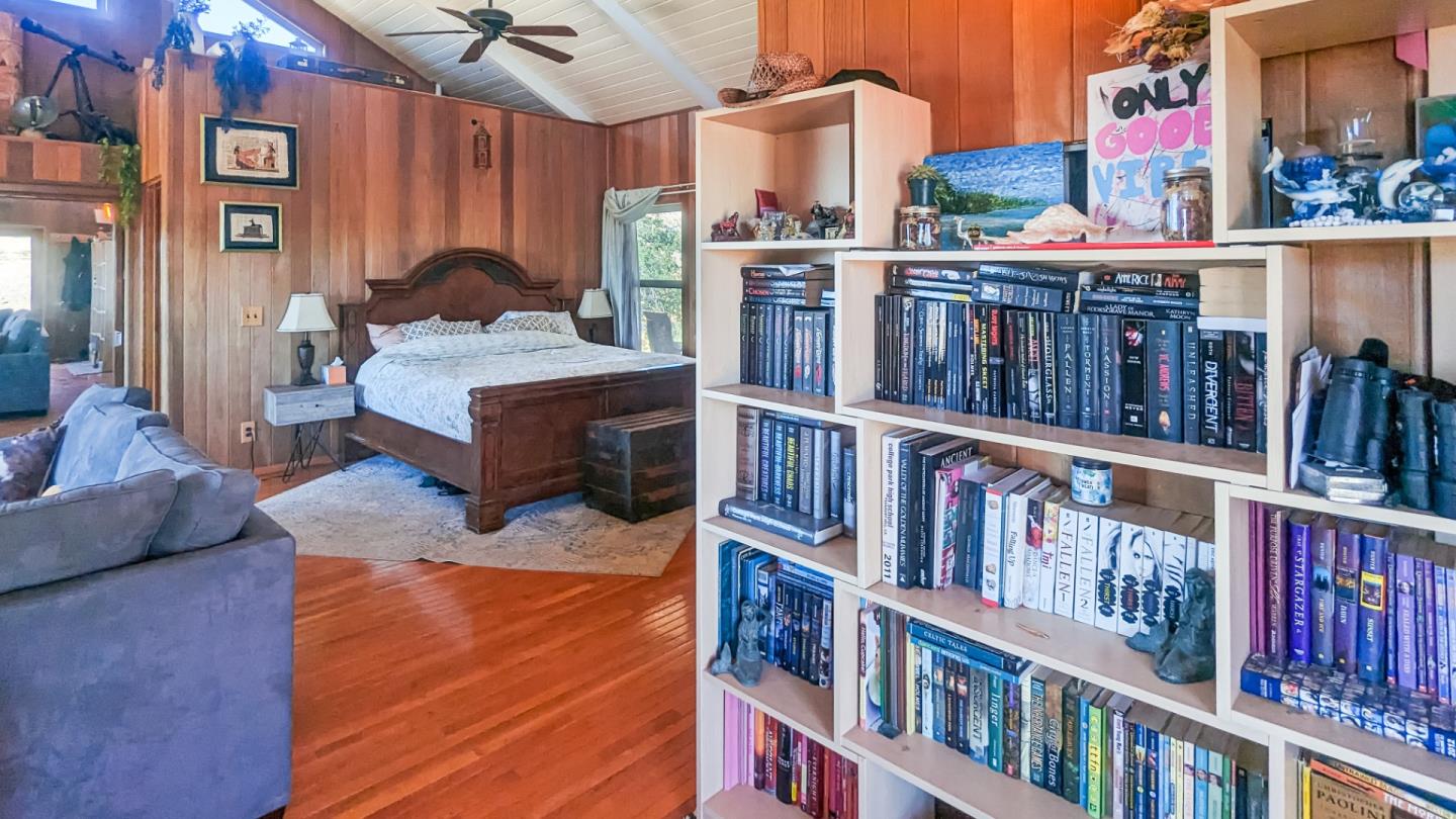 20473 Panoche Road Paicines, CA 95043 - Photo 13 of 19 a living room with lots of furniture and a book shelf