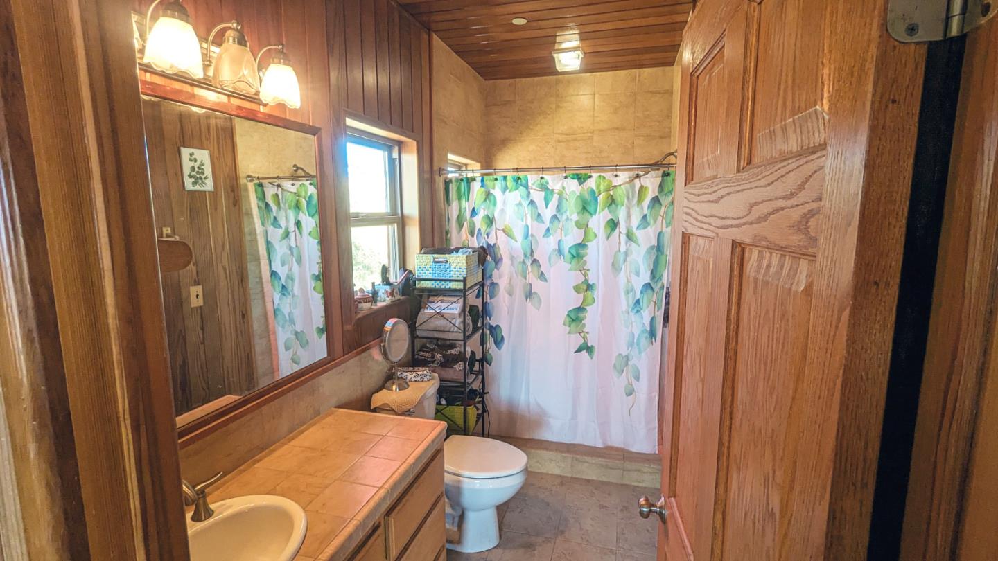 20473 Panoche Road Paicines, CA 95043 - Photo 9 of 19 a bathroom with a granite countertop sink toilet and shower