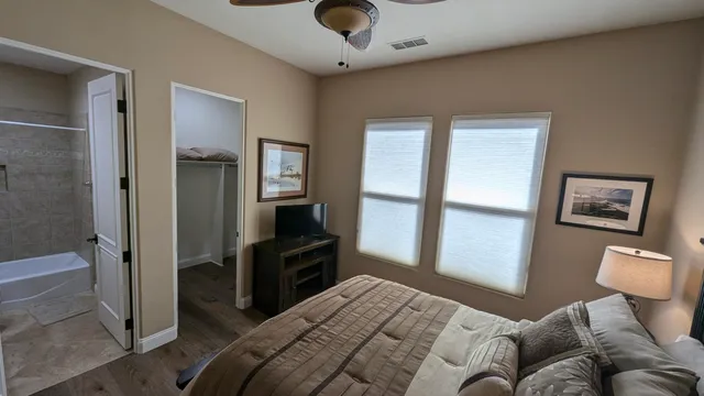 a bedroom with a bed and wooden floor