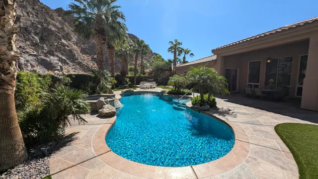 a view of a backyard with plants and a patio