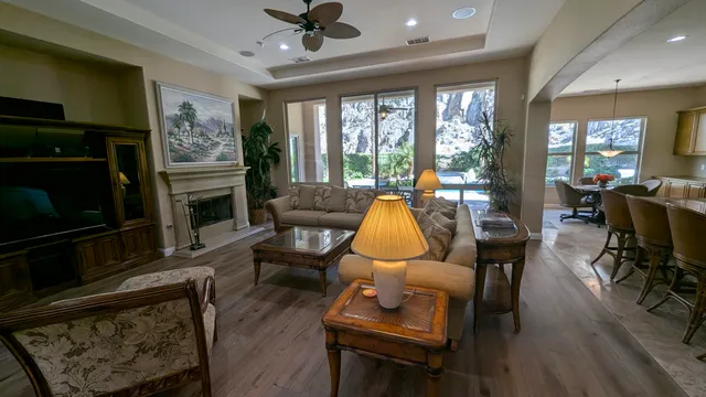 a living room with furniture a fireplace and a flat screen tv