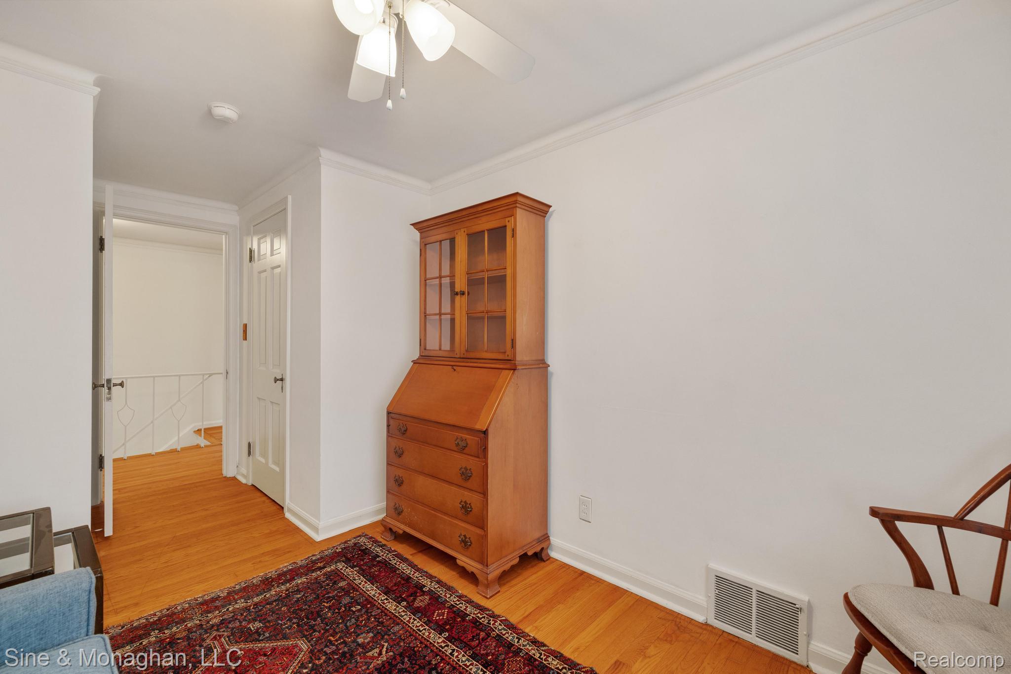 679 Neff Road Grosse Pointe, MI 48230 - Photo 29 of 78 Hardwood flooring, white crown molding, white doors, white ceiling fan, and white walls