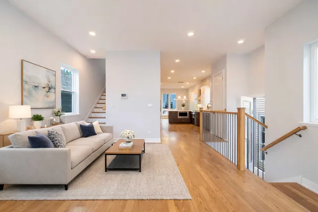 a view of a room with wooden floor and stairs