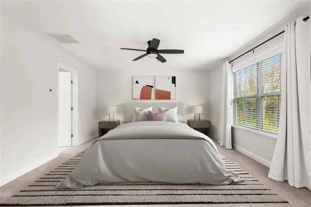 a bedroom with a bed and window