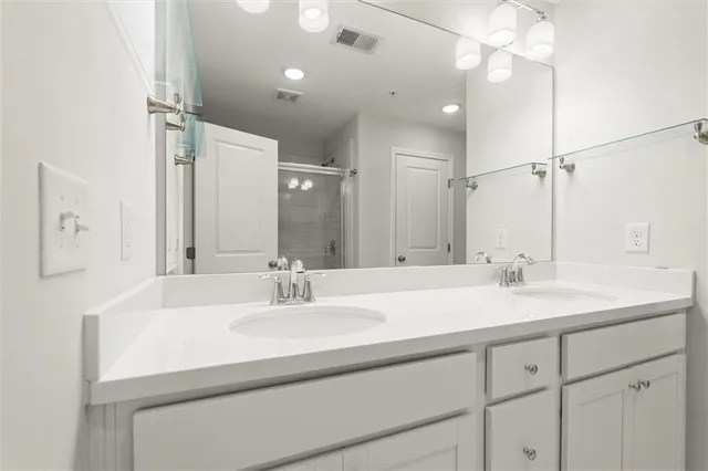 a bathroom with a glass shower door