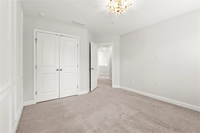 a bedroom with a bed a couch and window