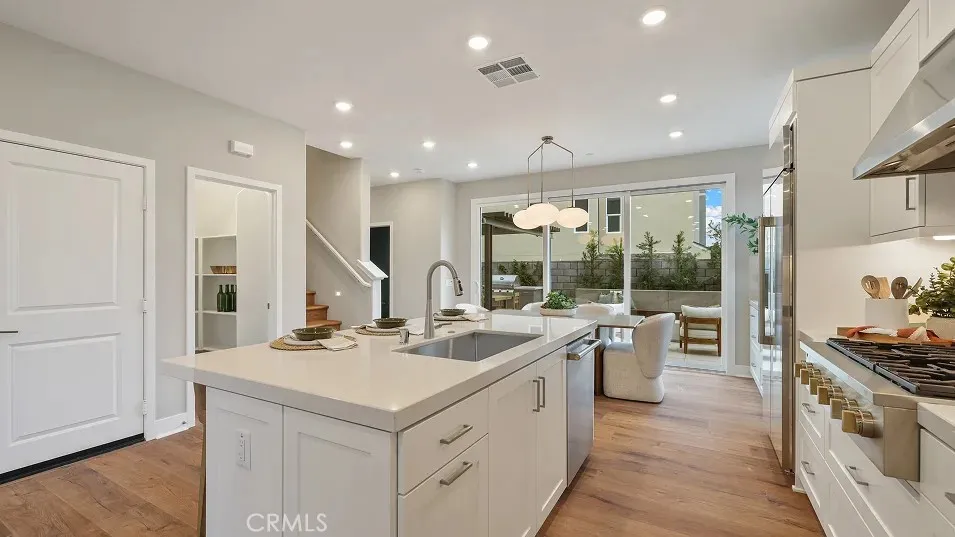 a kitchen with a sink stove and refrigerator