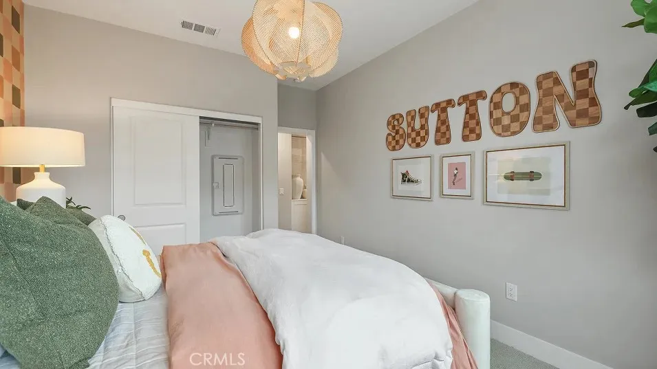 1709 Lychee Street Fullerton, CA 92835 - Photo 12 of 25 a bedroom with a bed and a chandelier