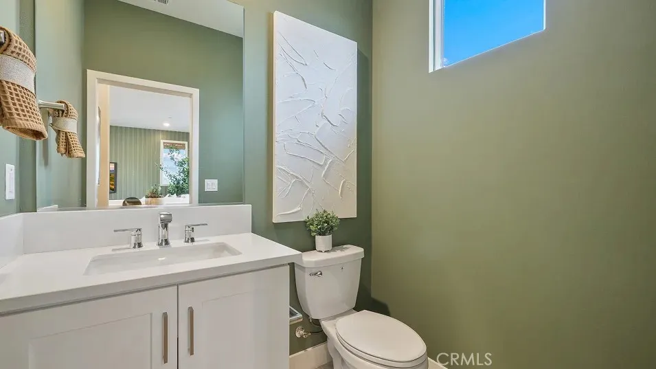 1709 Lychee Street Fullerton, CA 92835 - Photo 6 of 25 a bathroom with a toilet a sink and mirror