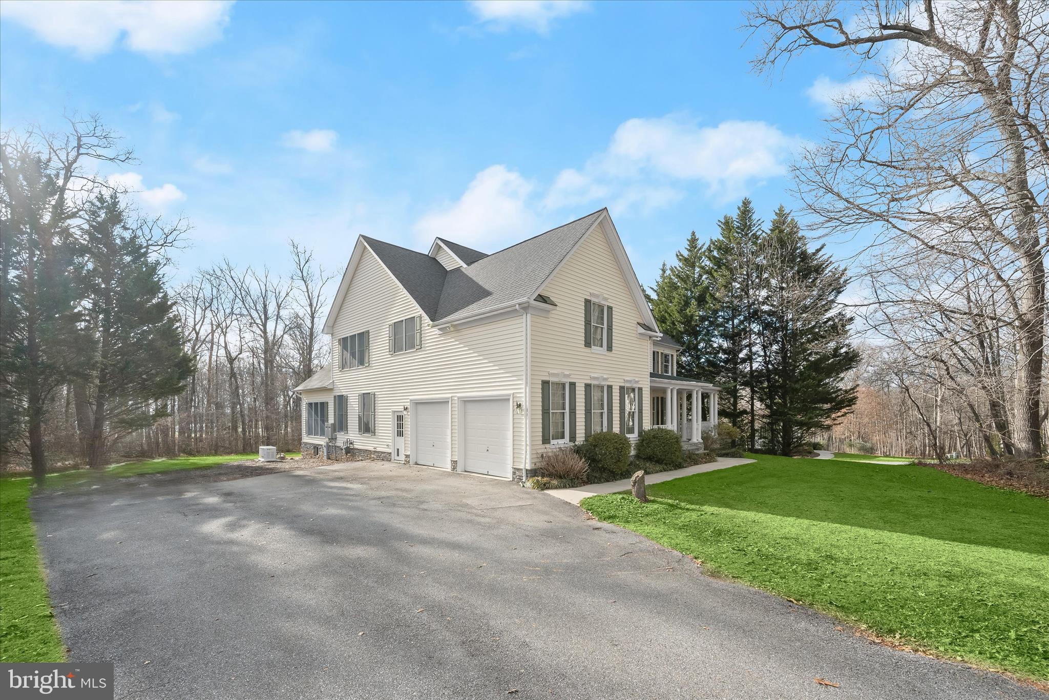 15286 Ridge Hunt Drive Woodbine, MD 21797 - Photo 1 of 100 a front view of house with yard and green space